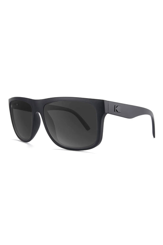 Black sunglasses with a brand logo on a white background
