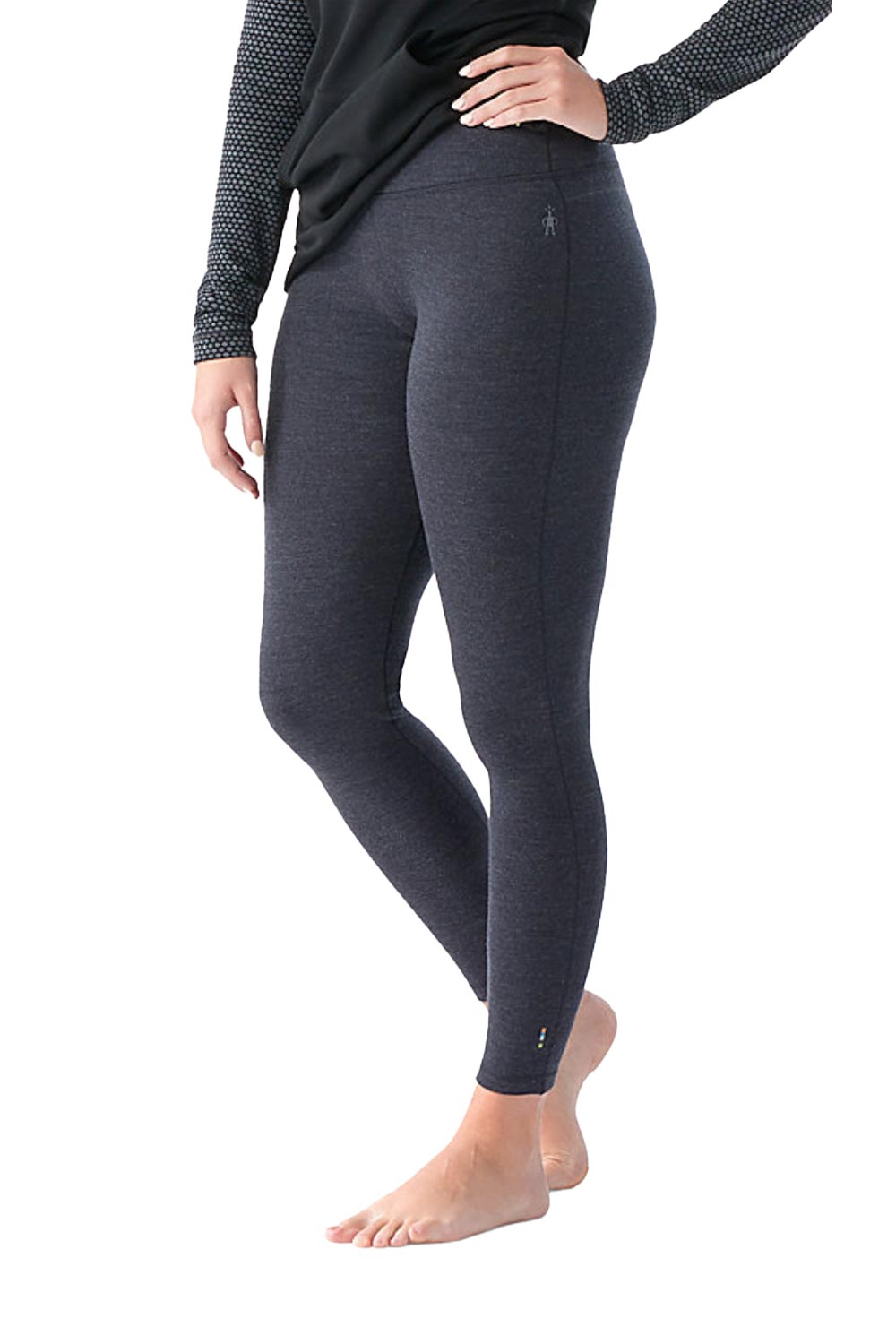 Person wearing dark gray leggings on a white background