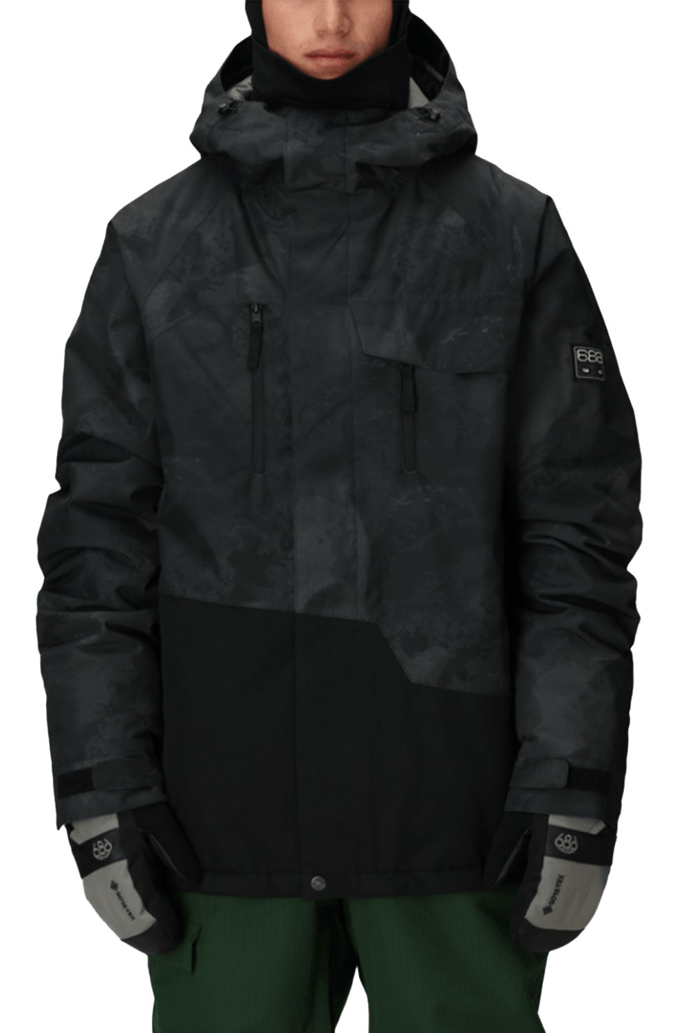 person wearing black camo snowboard jacket
