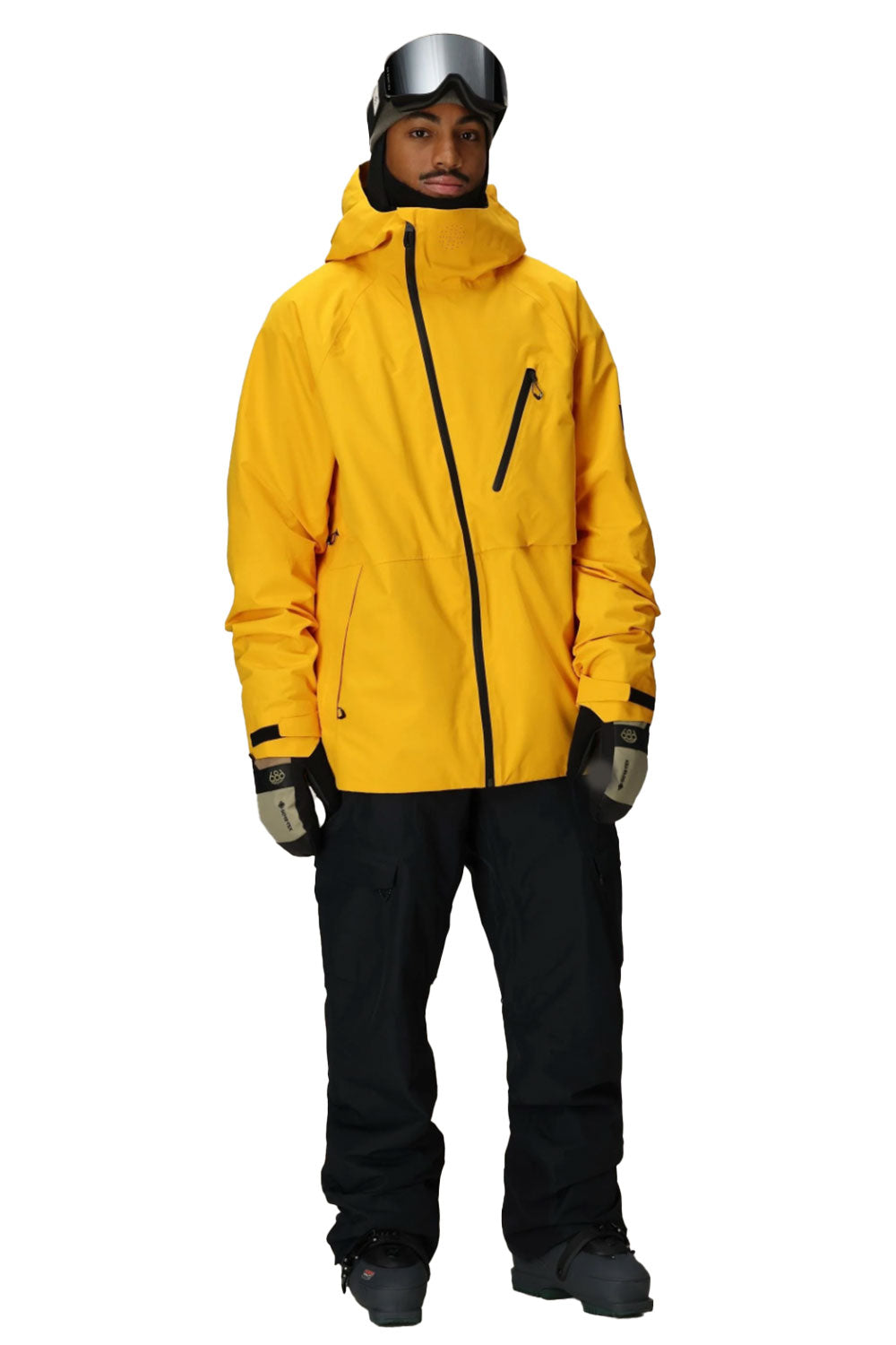 Person wearing a yellow jacket and black pants on a white background