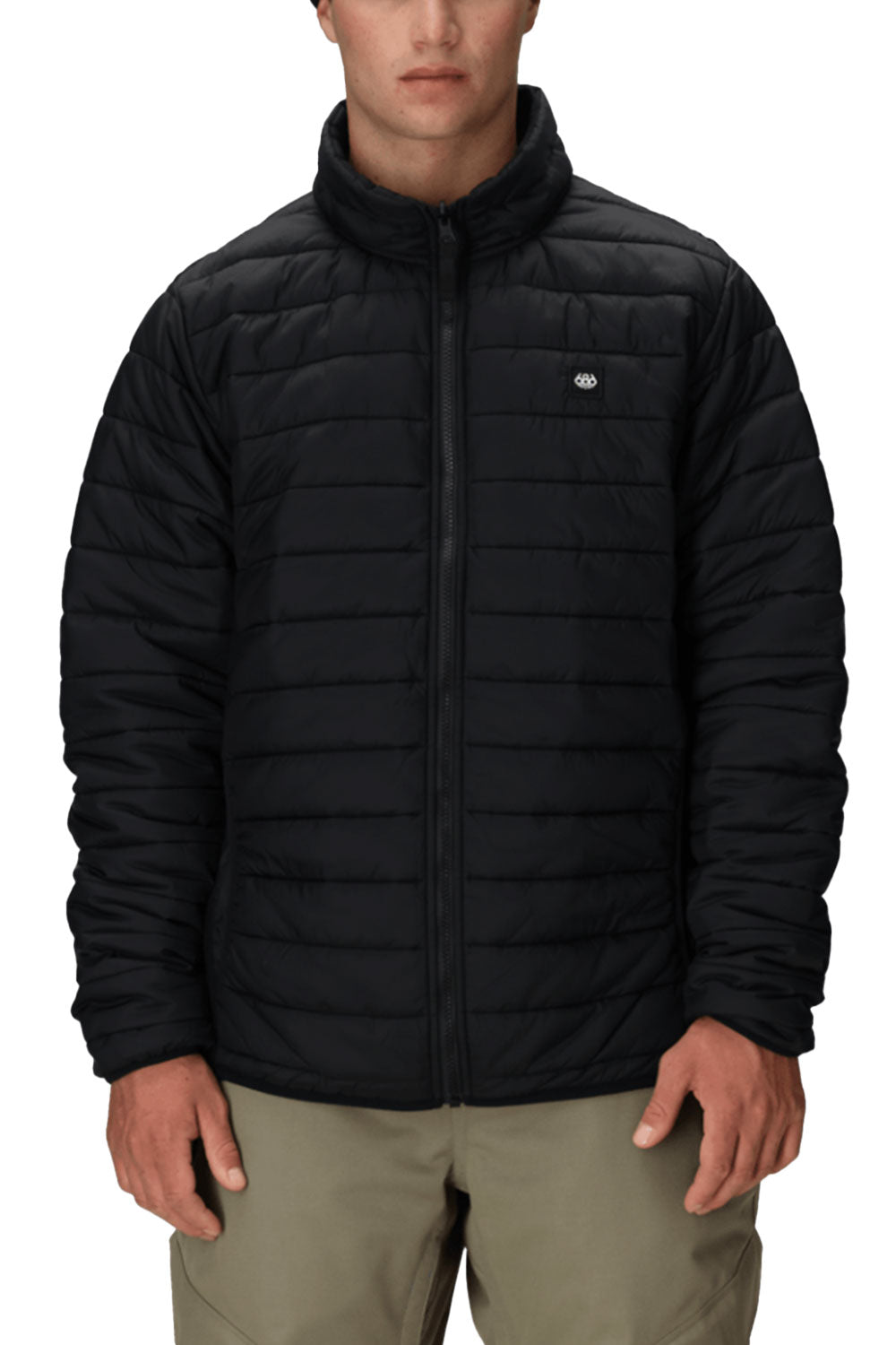 Black puffer jacket worn by a person on a white background