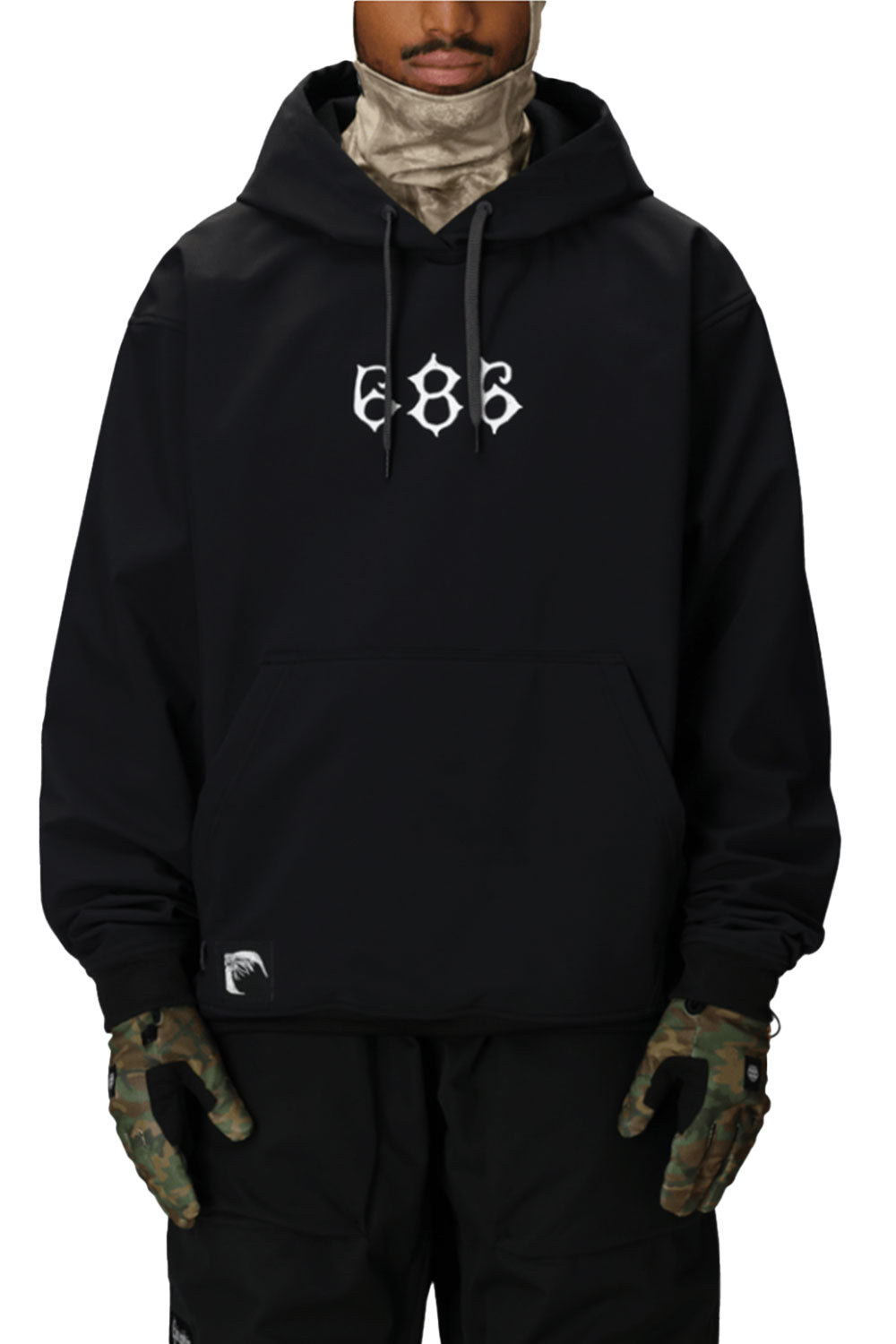 Person wearing a black hoodie with '686' logo, camouflage gloves, and pants on a white background
