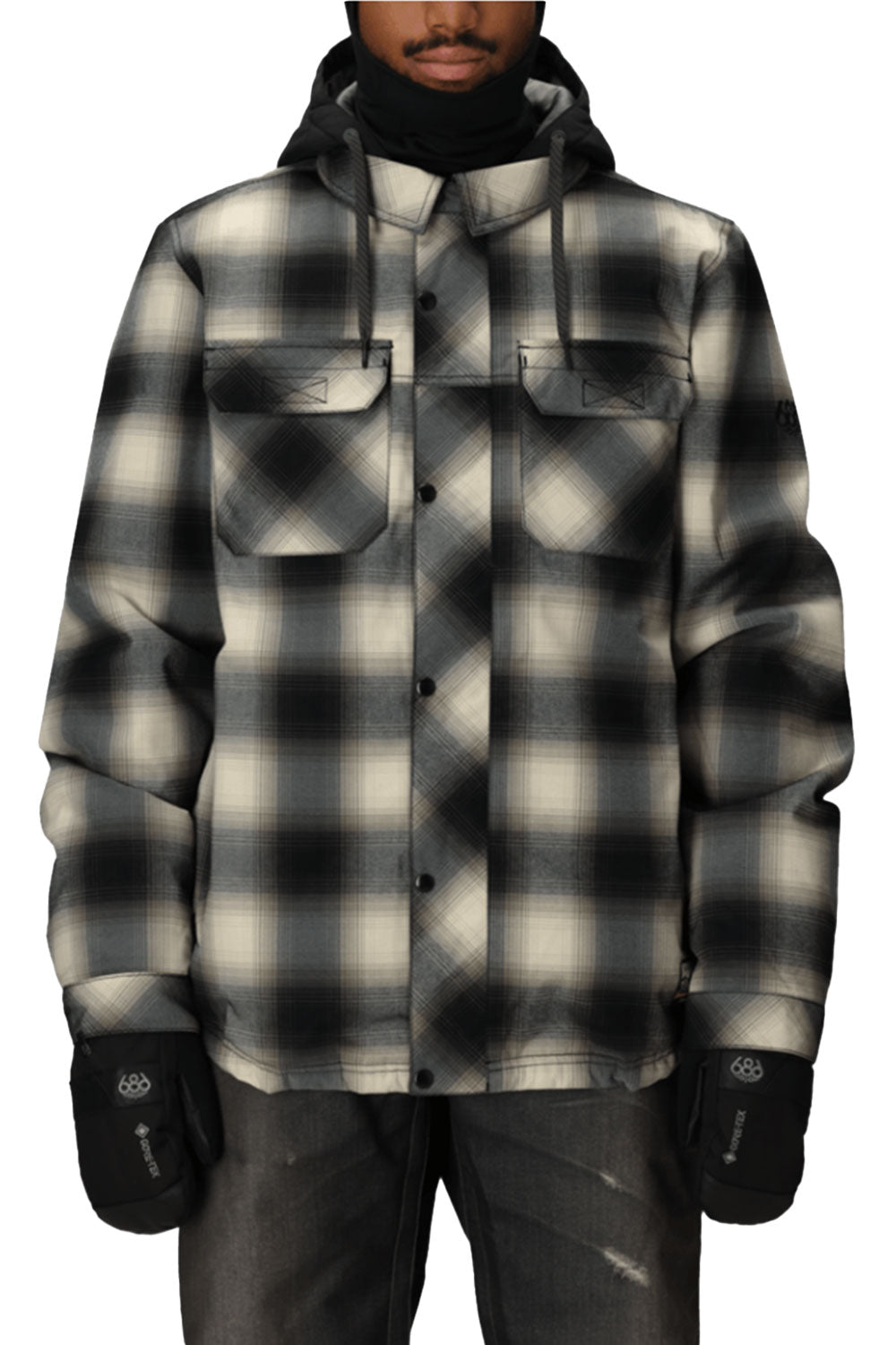Person wearing a black and gray checkered jacket with a hood on a white background