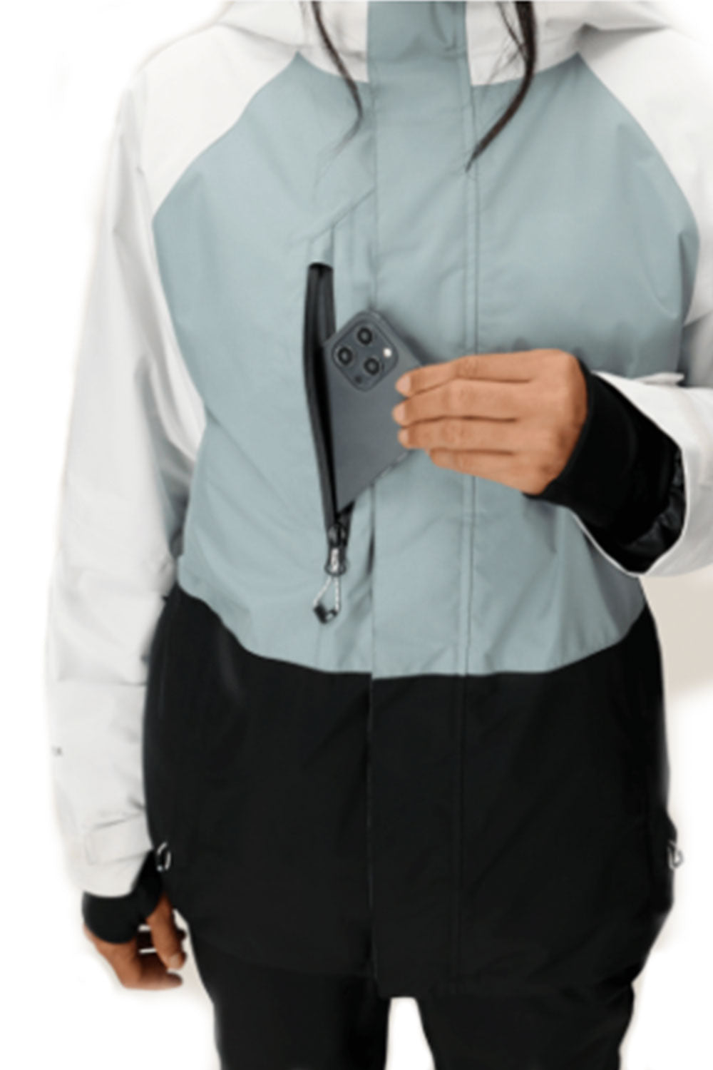 Person wearing a color-blocked jacket holding a phone with a white background