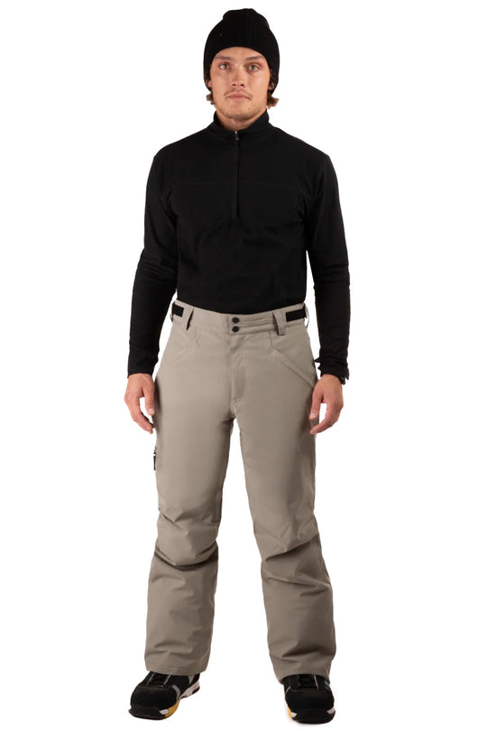 Man wearing a black jacket, black beanie, and beige pants on a white background