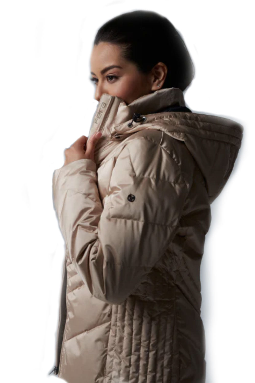 Woman wearing a beige quilted jacket on a white background