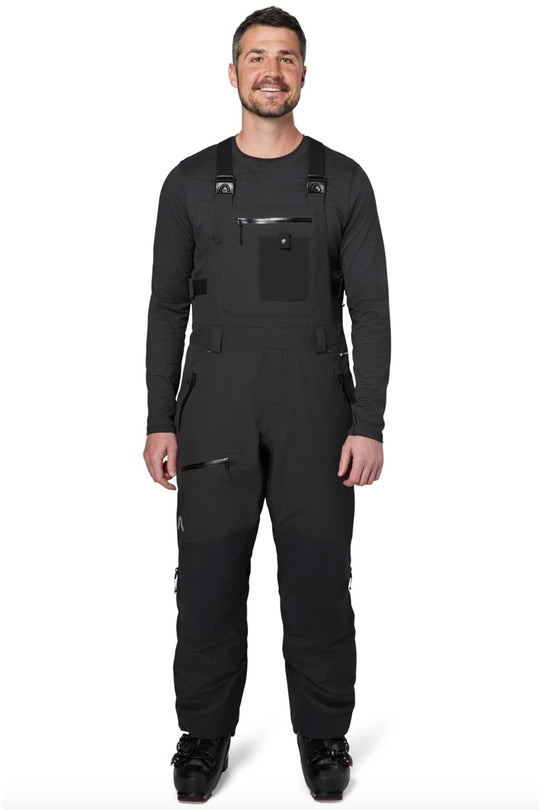Man wearing a black bib overalls on a white background