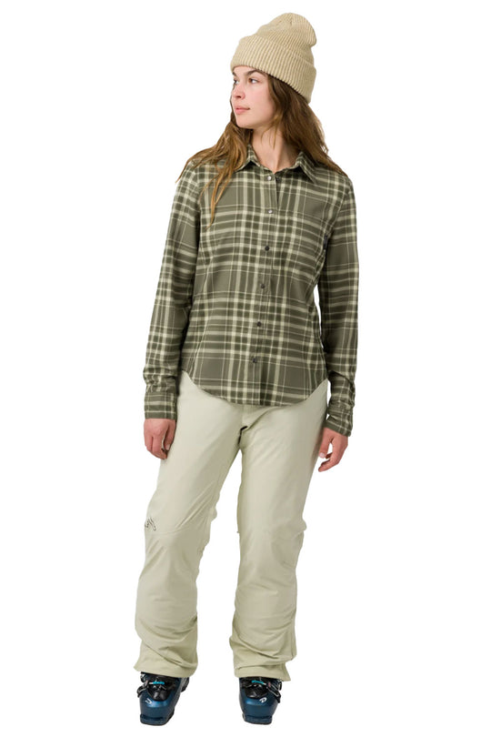 Person wearing a plaid shirt and beige pants on a white background