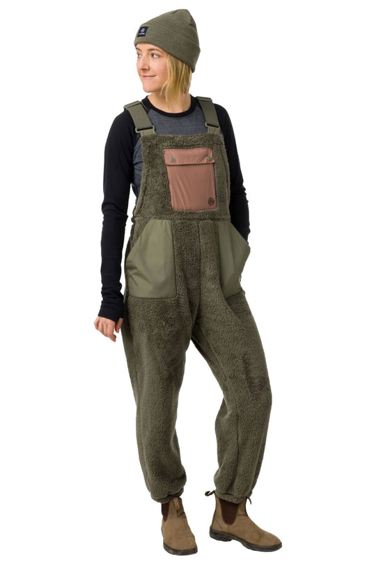Person wearing green overalls with a brown pocket on a white background
