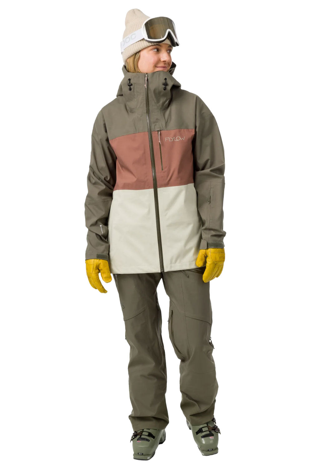 Person wearing a multi-colored snowboarding jacket and pants on a white background
