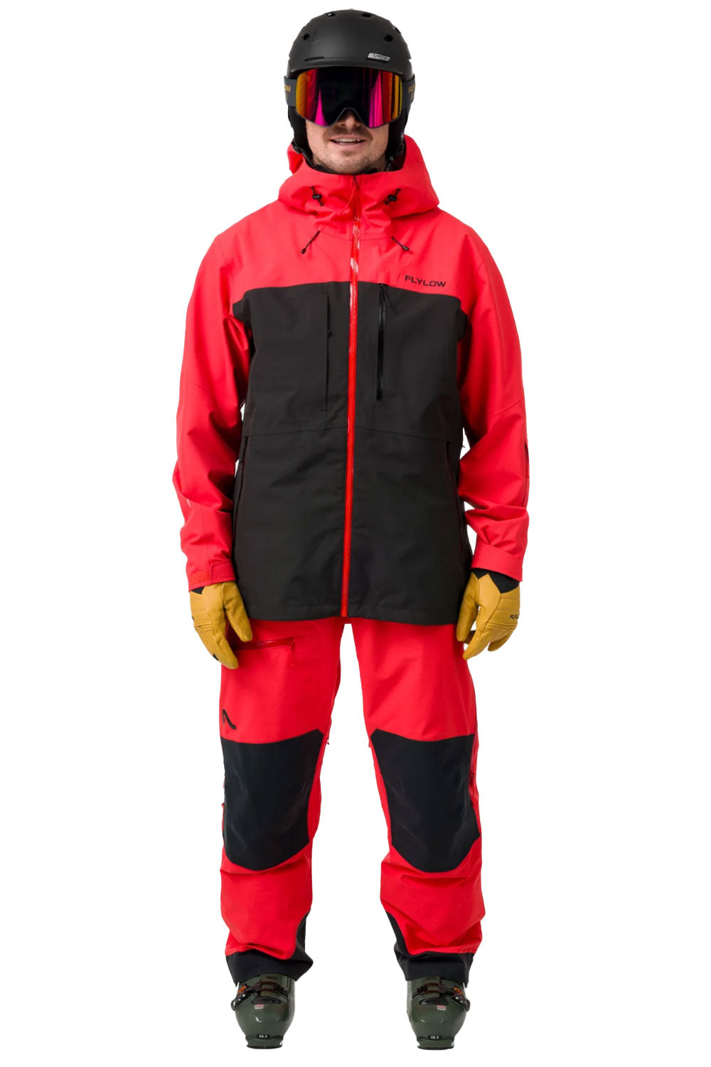 Person wearing a red and black ski jacket with goggles on a white background