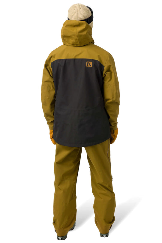 Person wearing a mustard yellow and black ski jacket on a white background