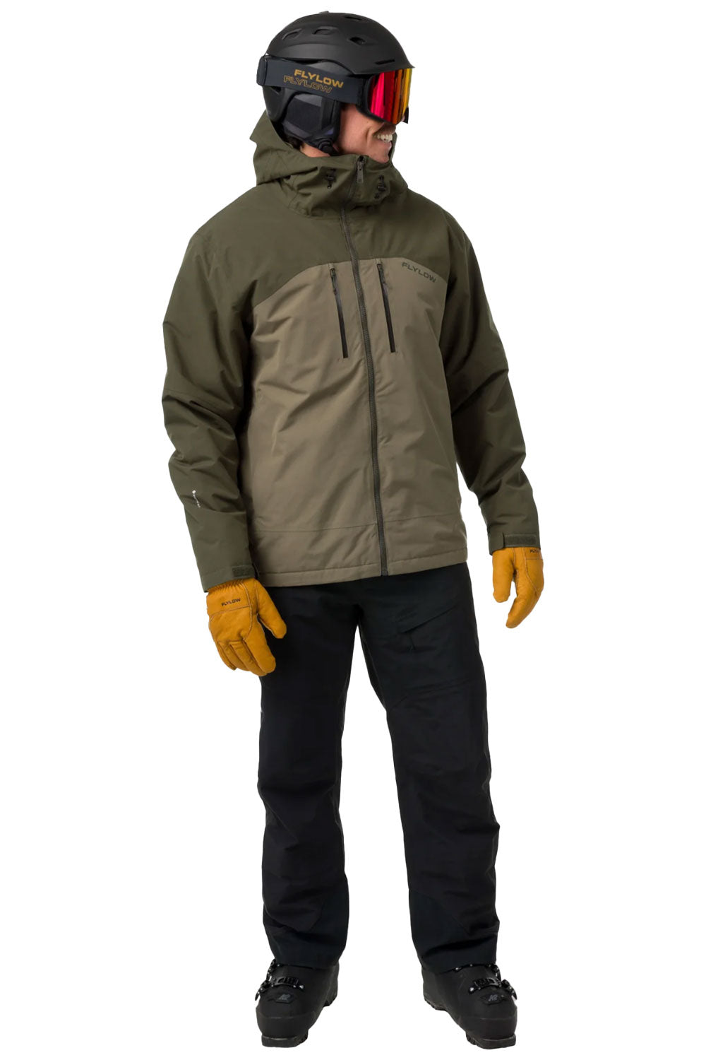 Person wearing a green and brown jacket, black pants, yellow gloves, and a helmet with goggles on a white background