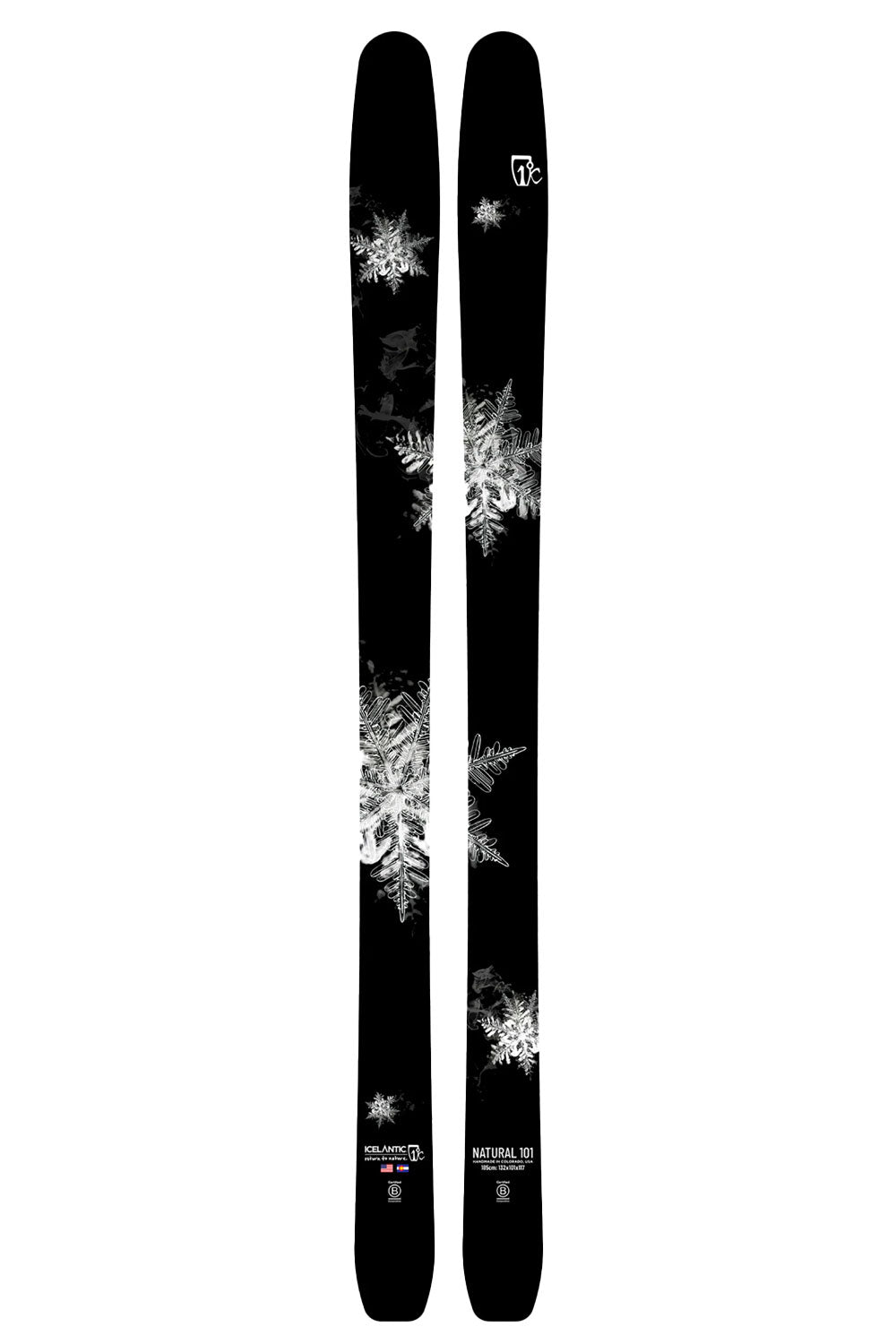 Two black skis with white snowflake patterns on a white background