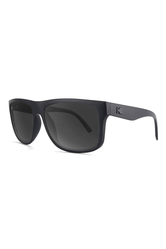 Black sunglasses with a brand logo on a white background