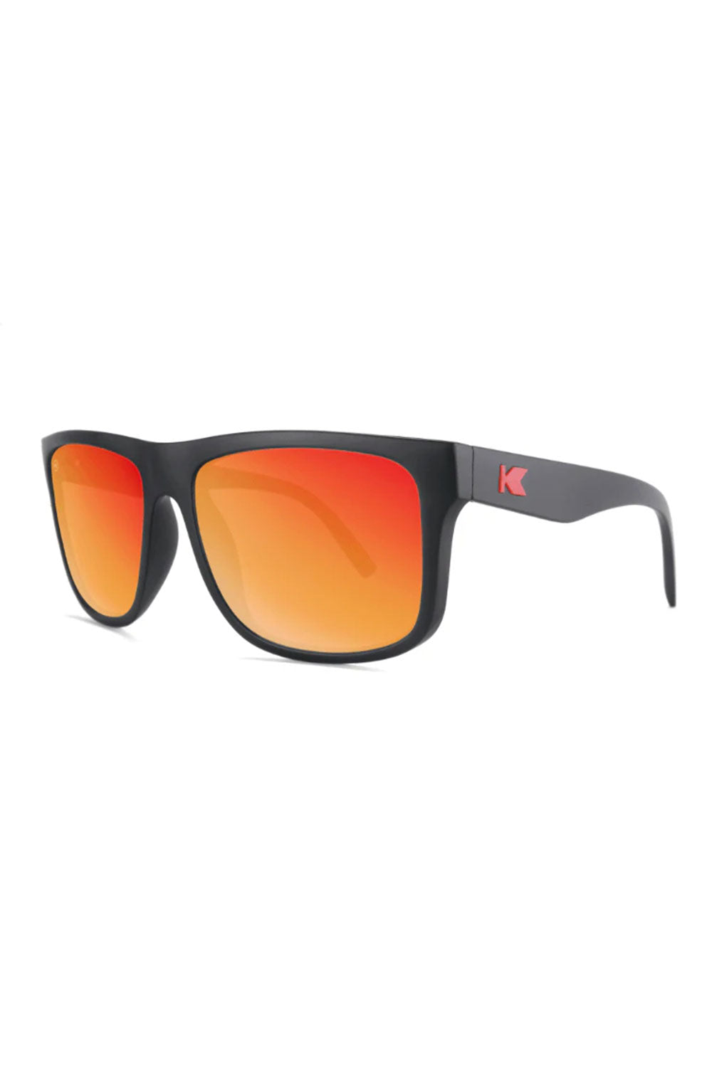Sunglasses with black frame and red-orange lenses on a white background