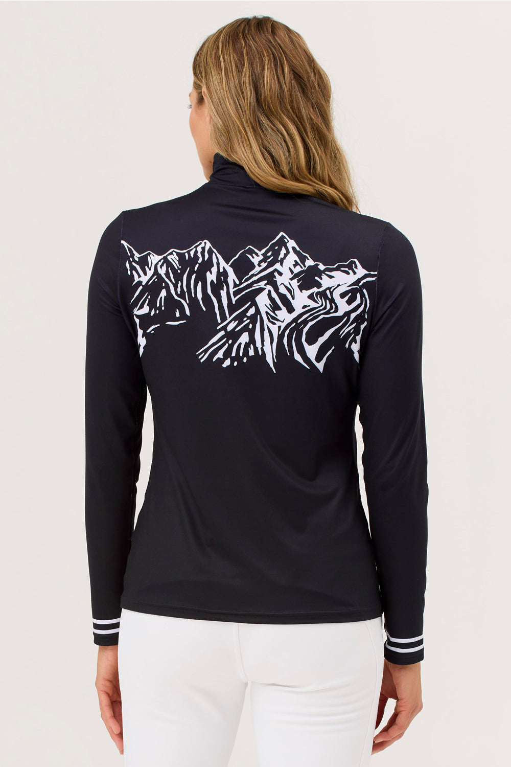 Woman wearing a black long-sleeve shirt with mountain design on the back.