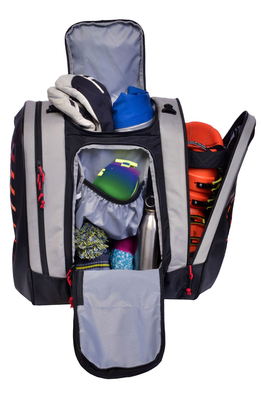 Open backpack with various items including a blue shoe, colorful hat, and a silver water bottle on a white background.