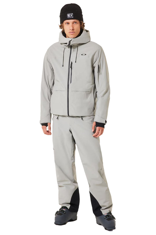 Person wearing a gray snowsuit with black accents on a white background