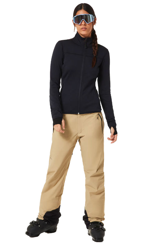 Person wearing a black jacket and beige pants with goggles on a white background
