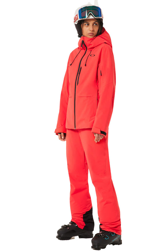 Person wearing a bright red ski suit with a helmet on a white background
