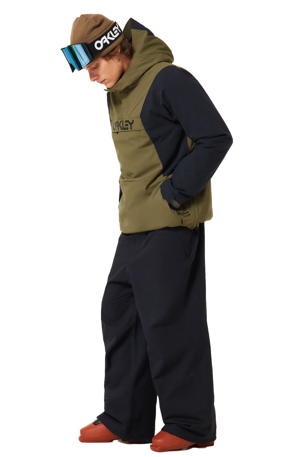 Person wearing a green and black snowsuit with a white background