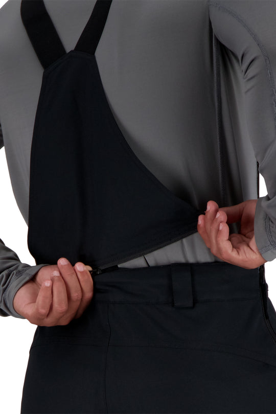 Person wearing black ski bib pants