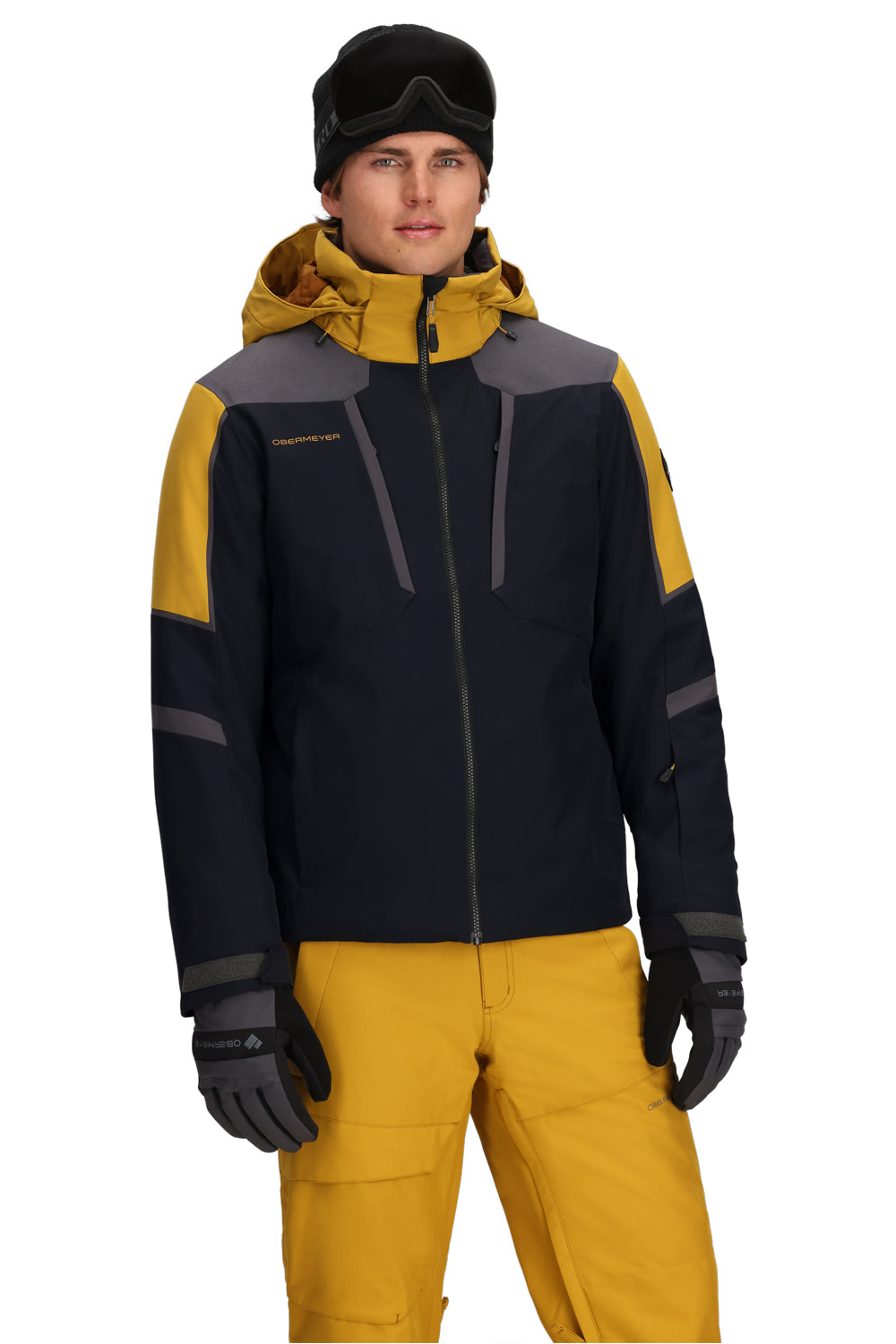 Person wearing a black and yellow ski jacket with a white background