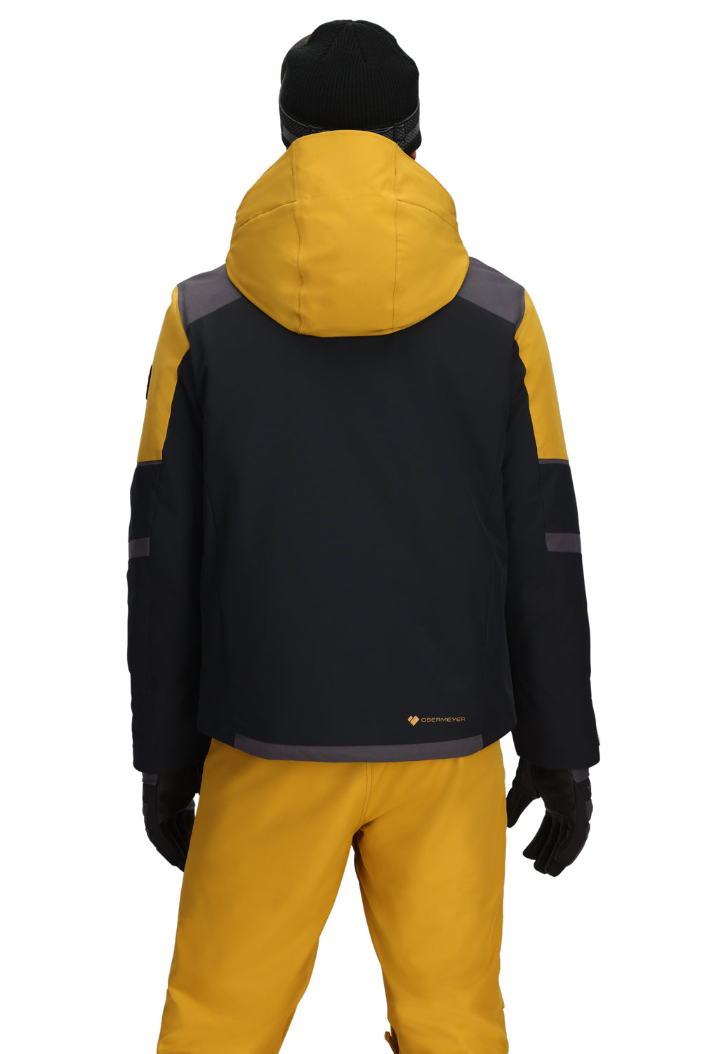 Person wearing a black and yellow ski jacket with a hood on a white background
