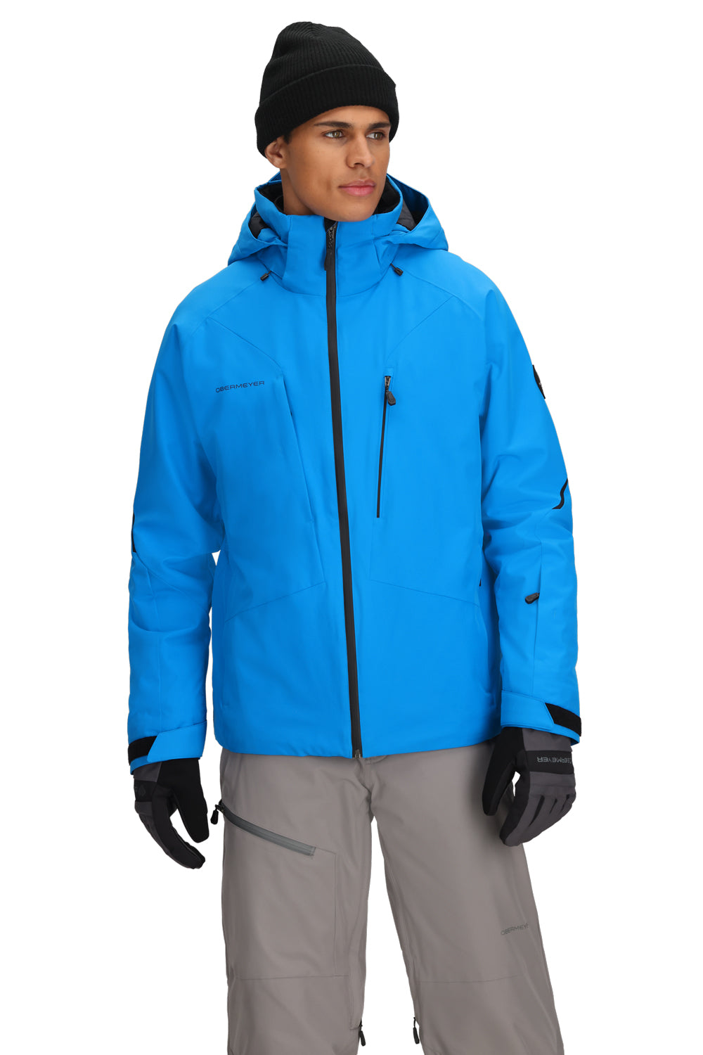 Person wearing a blue jacket, gray pants, and black gloves on a white background