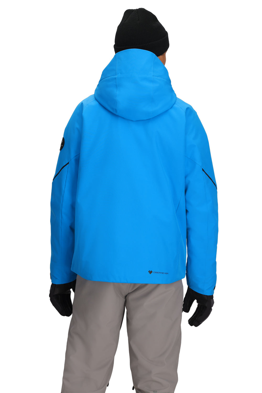 Person wearing a blue jacket, gray pants, and black gloves on a white background