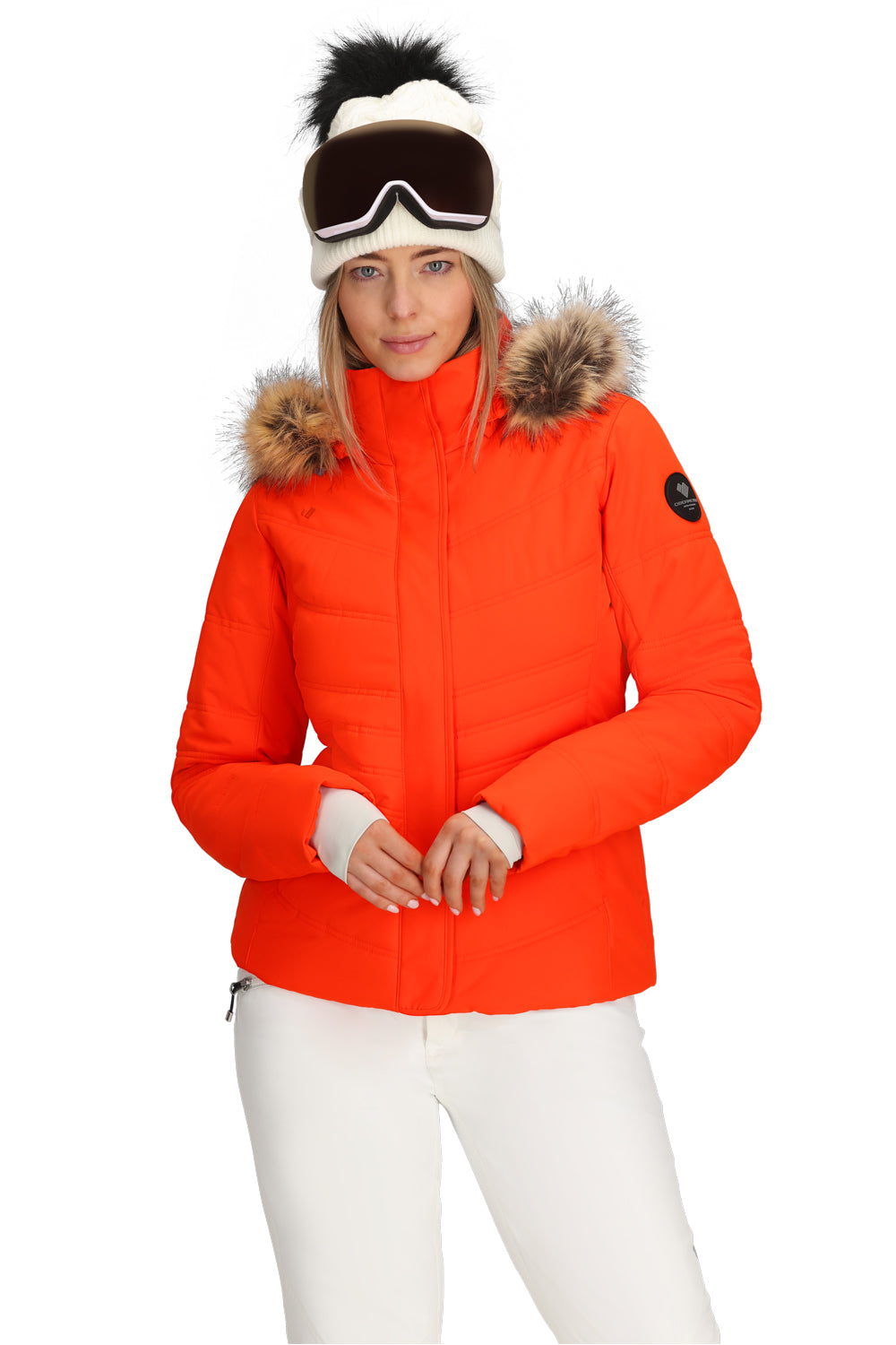 Person wearing an orange ski jacket with fur hood on a white background