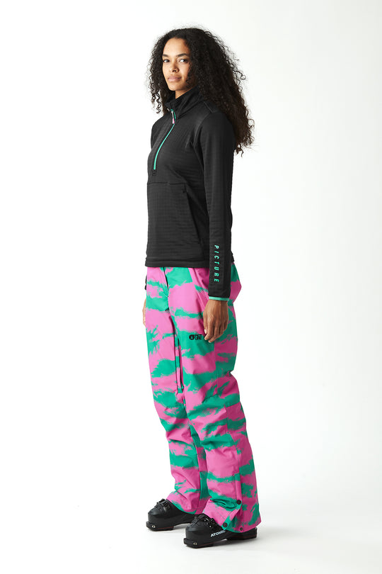 Person wearing a black jacket and pink camouflage pants on a white background
