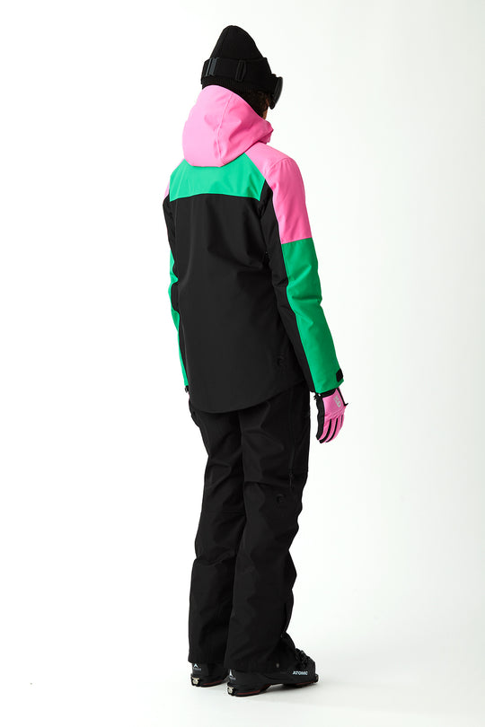 Person wearing a colorful jacket with black pants on a white background
