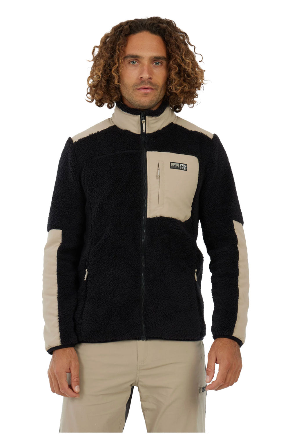 Man wearing a black and beige fleece jacket on a white background