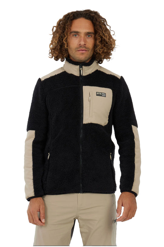Man wearing a black and beige fleece jacket on a white background