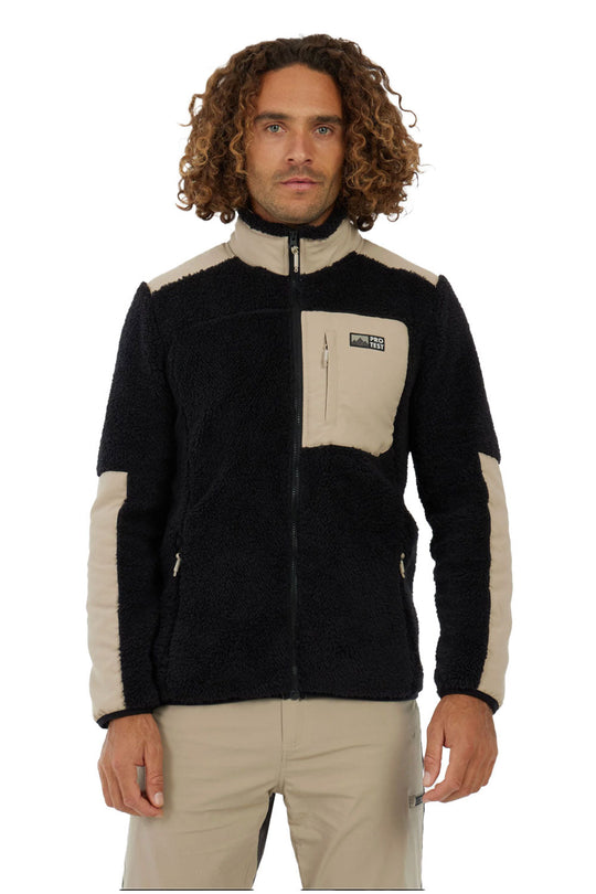 Man wearing a black and beige fleece jacket on a white background