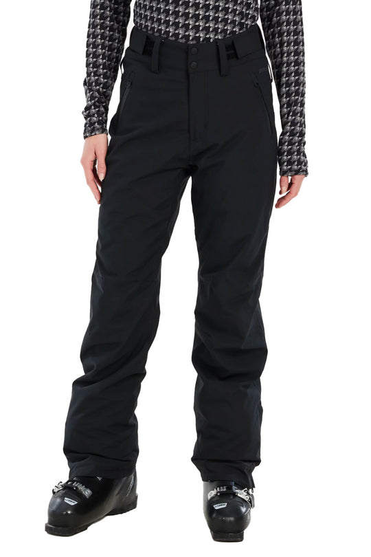 Person wearing black snow pants with a patterned top and ski boots on a white background