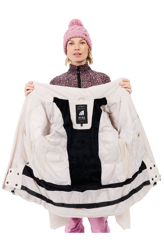 Person holding a white winter coat with a brand label on a white background