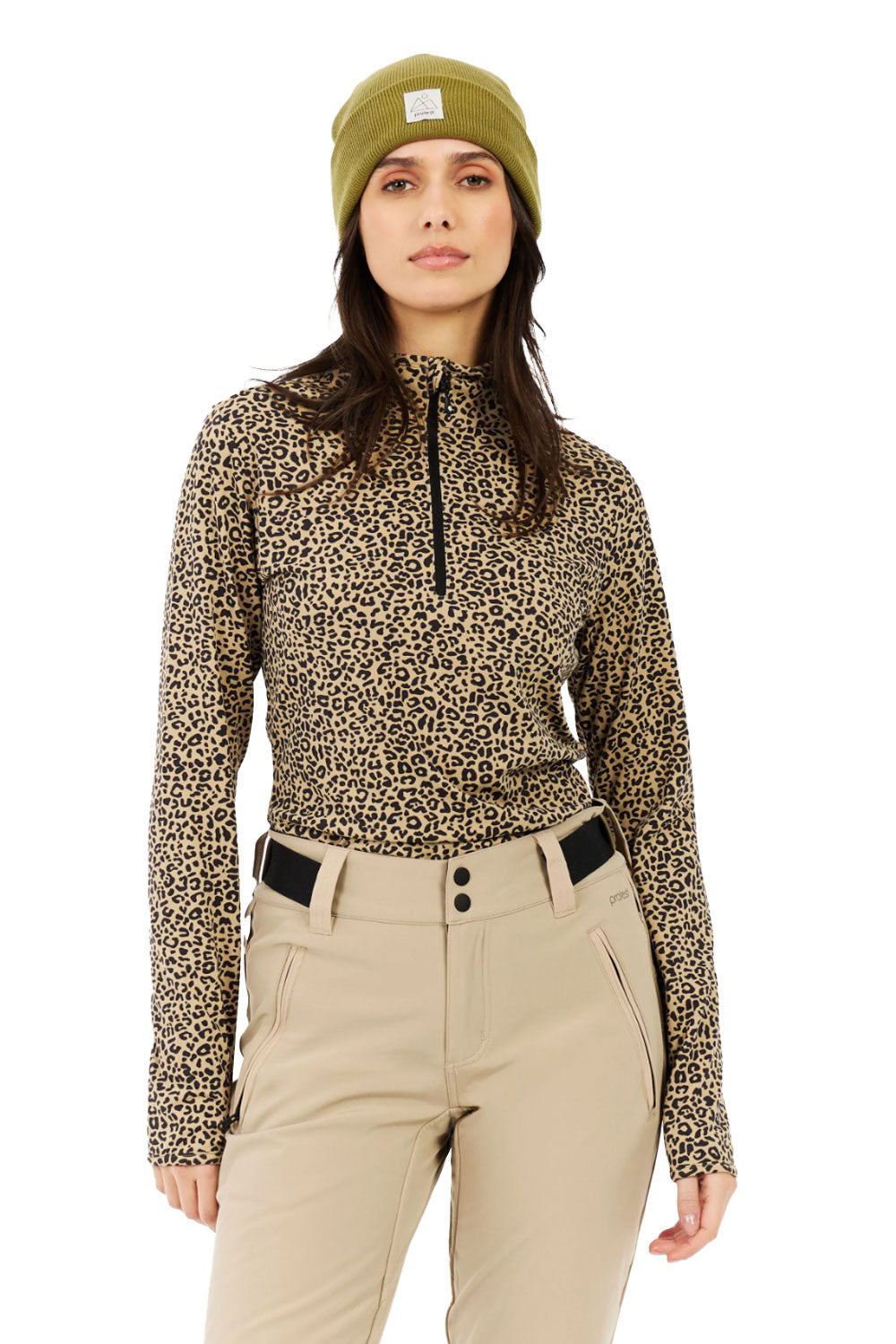 Person wearing a leopard print long-sleeve top and beige pants with a green beanie on a white background