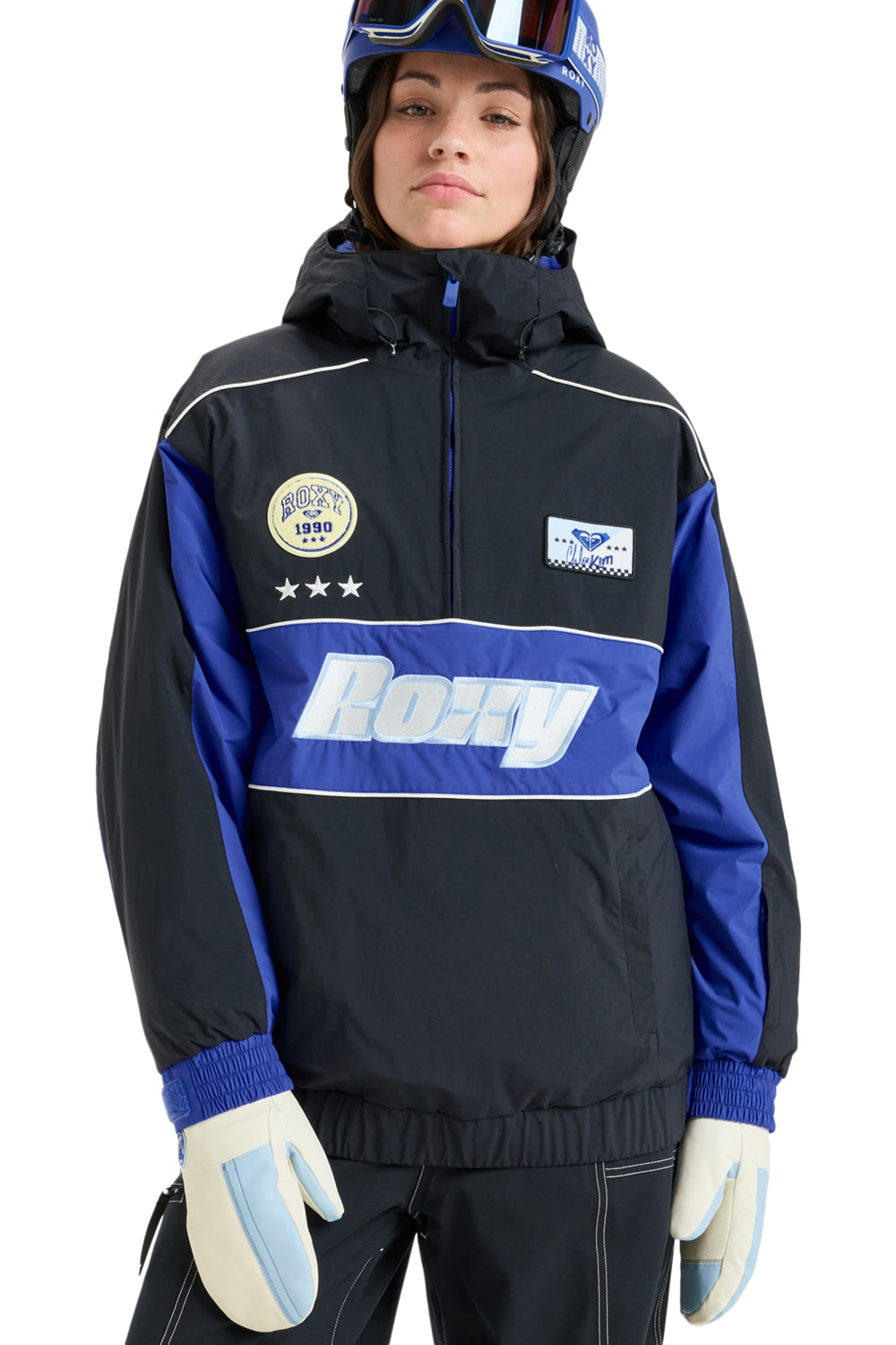Person wearing a black and blue  snowboard jacket with Roxy branding on a white background