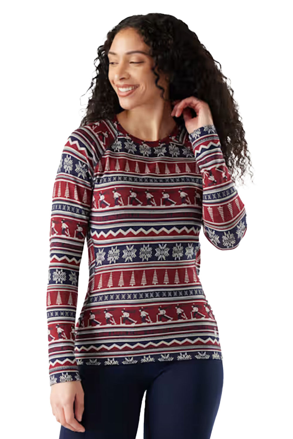 Woman wearing a patterned base layer top with reindeer and snowflakes on a white background