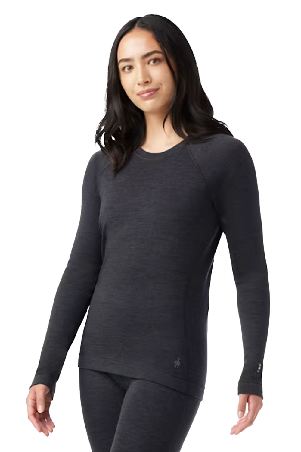 Woman wearing a dark gray long-sleeve top on a white background
