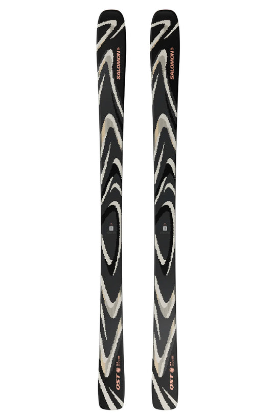 Two black skis with white patterns on a white background