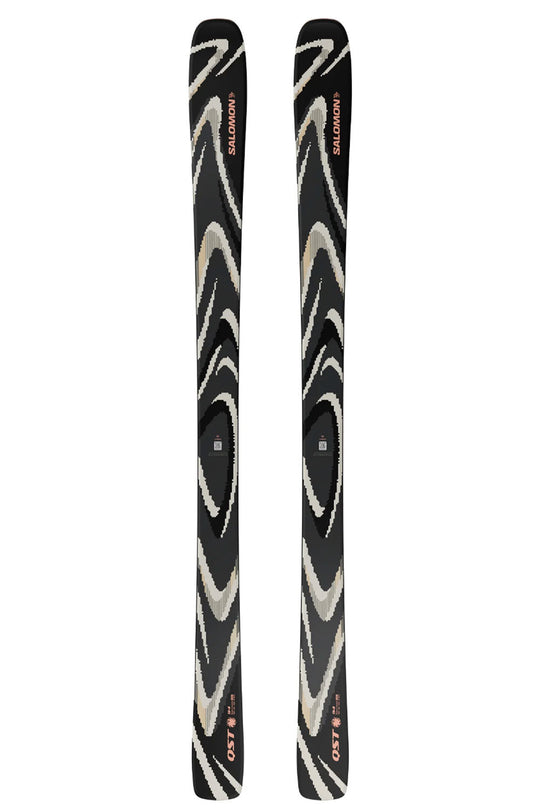 Two black skis with white patterns on a white background