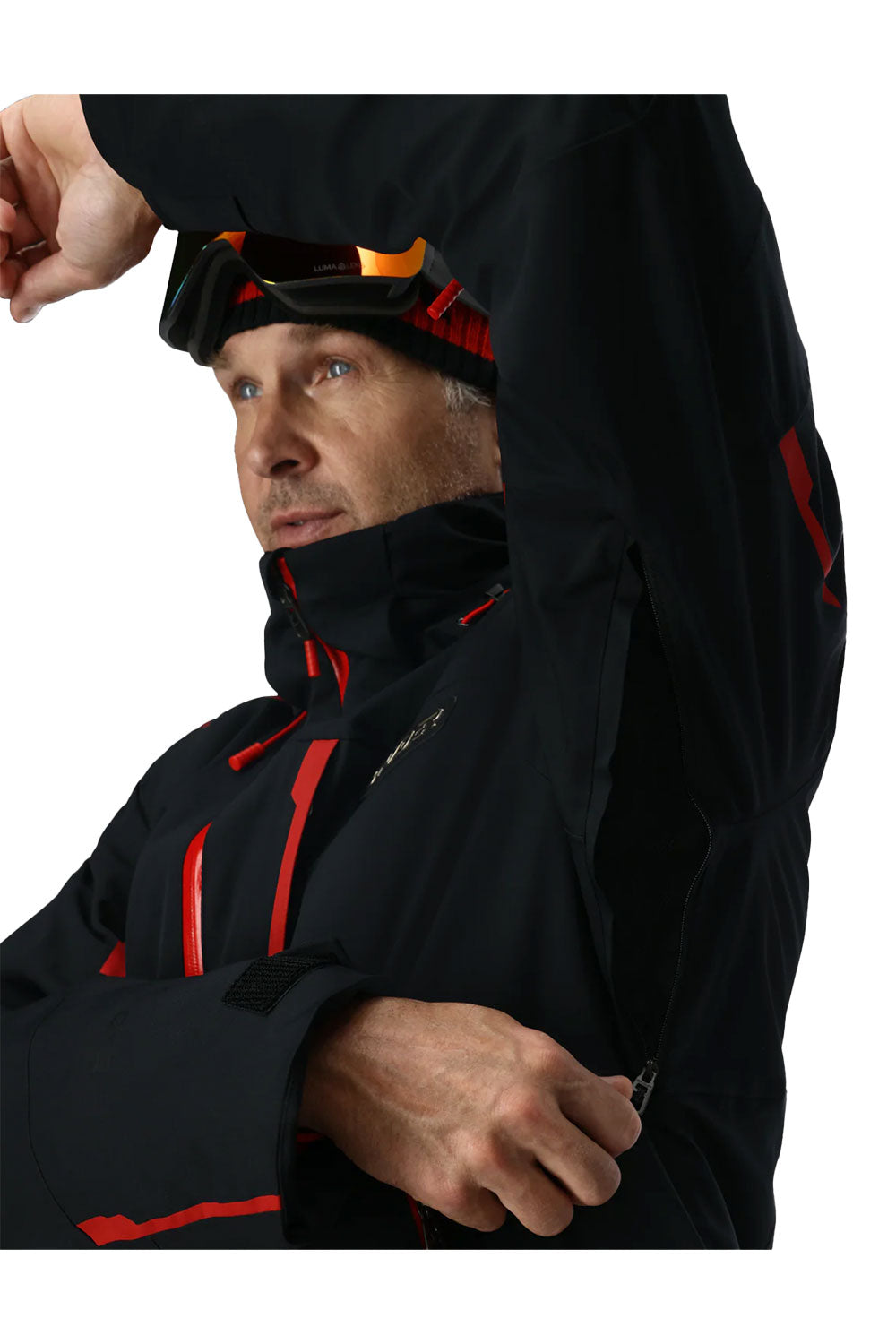 Person wearing a black jacket with red accents, adjusting an armpit vent