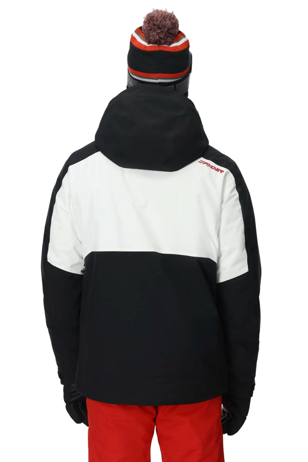 Person wearing a black and white jacket with red pants on a white background