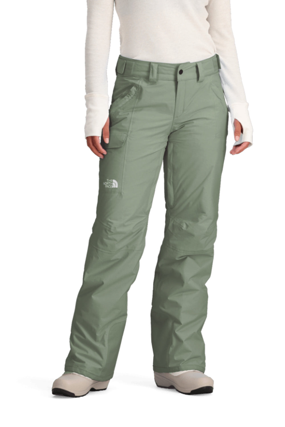 Green snow pants worn by a person on a white background