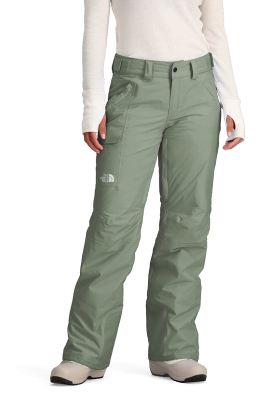 Green snow pants worn by a person on a white background