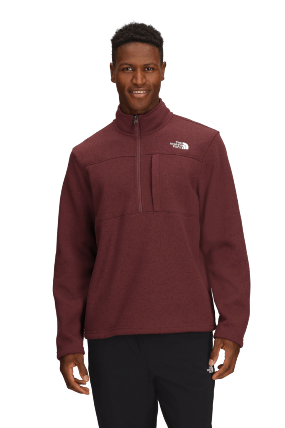 Man wearing a maroon fleece pullover with a brand logo on a white background